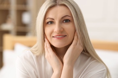 Portrait of beautiful woman with blonde hair indoors