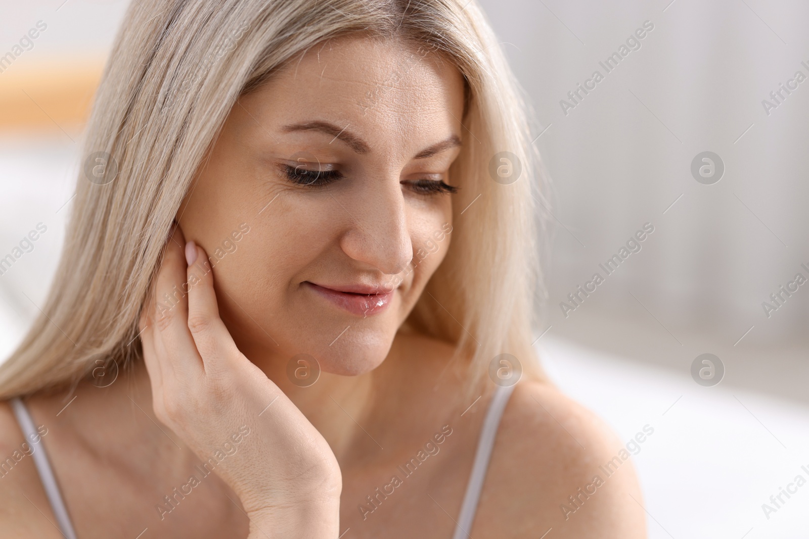 Photo of Portrait of beautiful woman with blonde hair indoors