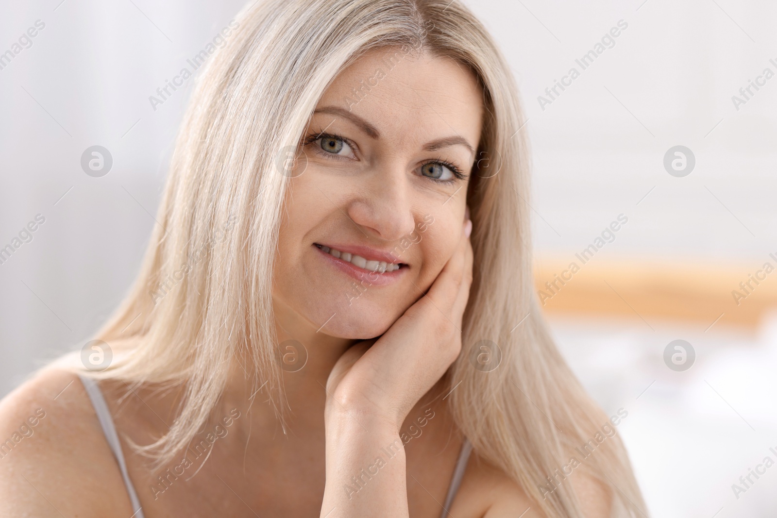 Photo of Portrait of beautiful woman with blonde hair indoors