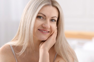 Portrait of beautiful woman with blonde hair indoors