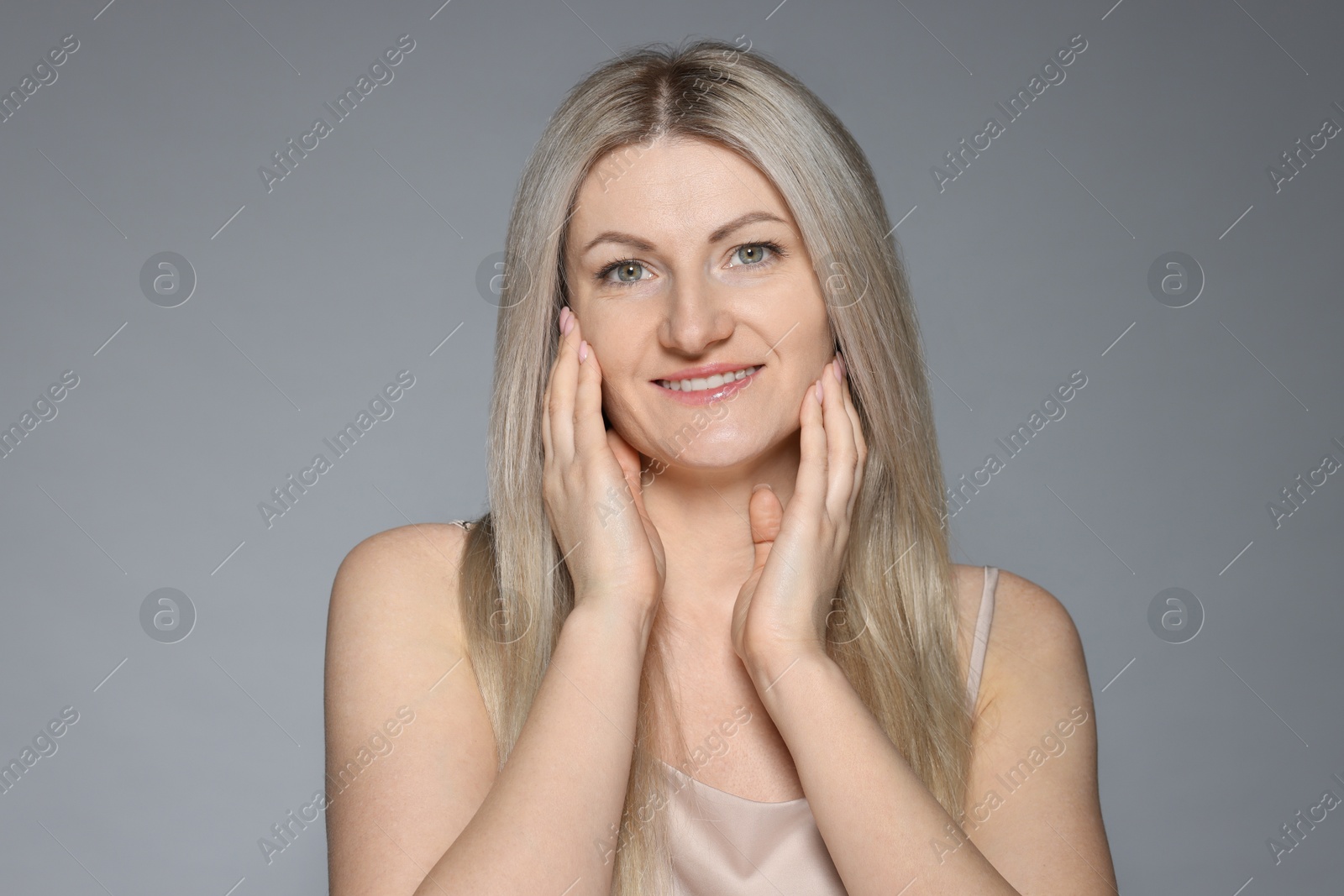 Photo of Portrait of beautiful woman on grey background