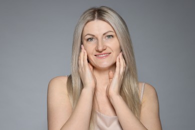 Photo of Portrait of beautiful woman on grey background