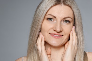 Photo of Portrait of beautiful woman on grey background