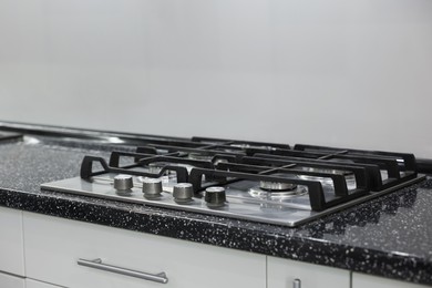 Stove with burners on counter in kitchen