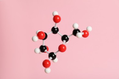 Photo of Molecule of glucose on pink background. Chemical model