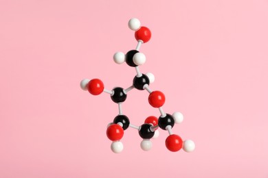 Photo of Molecule of glucose on pink background. Chemical model