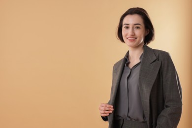 Photo of Portrait of smiling secretary against dark beige background. Space for text