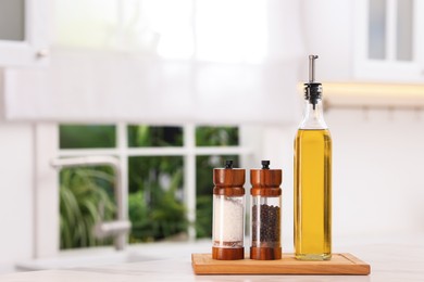 Photo of Salad dressing and spices on table in kitchen. Space for text