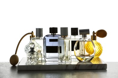 Photo of Many different luxury perfumes on grey table