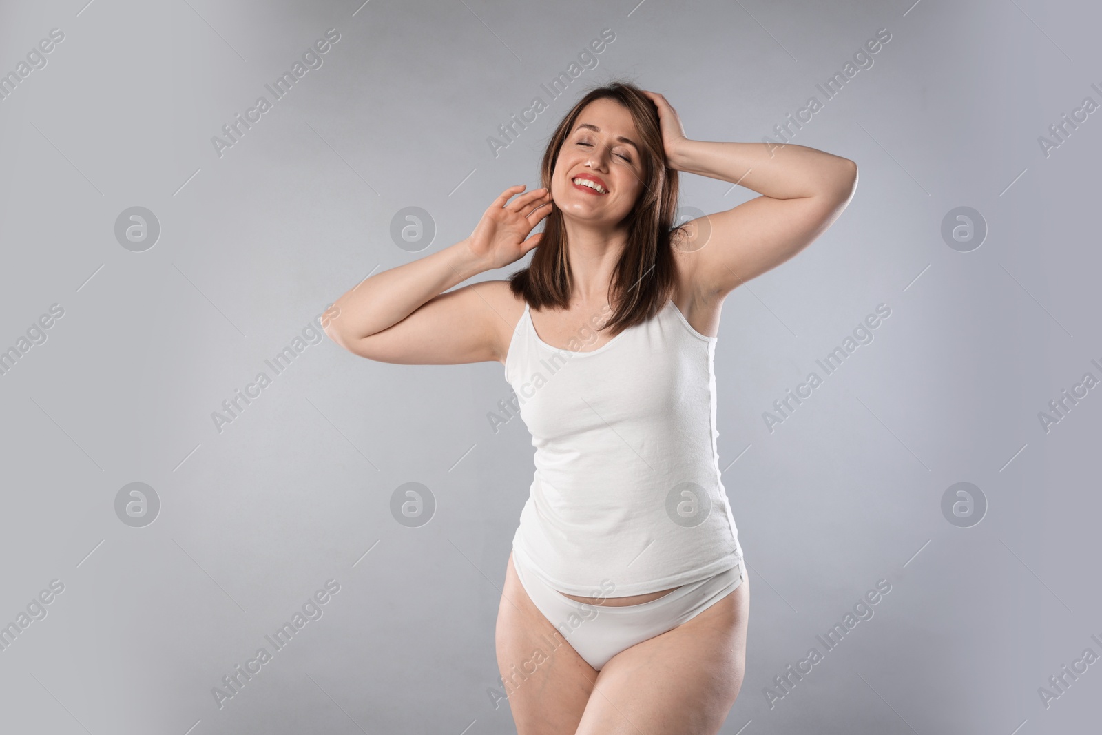 Photo of Woman in underwear on light grey background. Cellulite problem