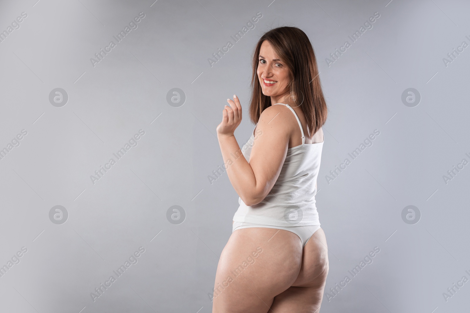 Photo of Woman in underwear on light grey background, space for text. Cellulite problem