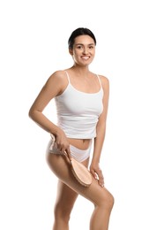 Woman doing anti cellulite massage with brush on white background