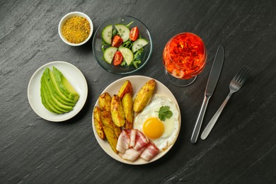 Photo of Flat lay composition with tasty brunch served on dark textured table