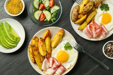 Photo of Flat lay composition with tasty brunch served on dark textured table