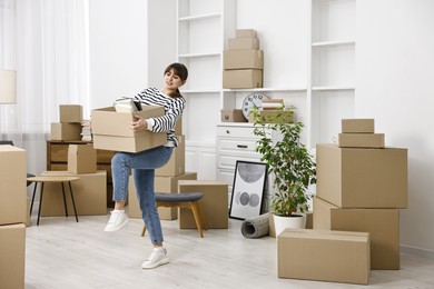 Moving day. Woman with her belongings in new home