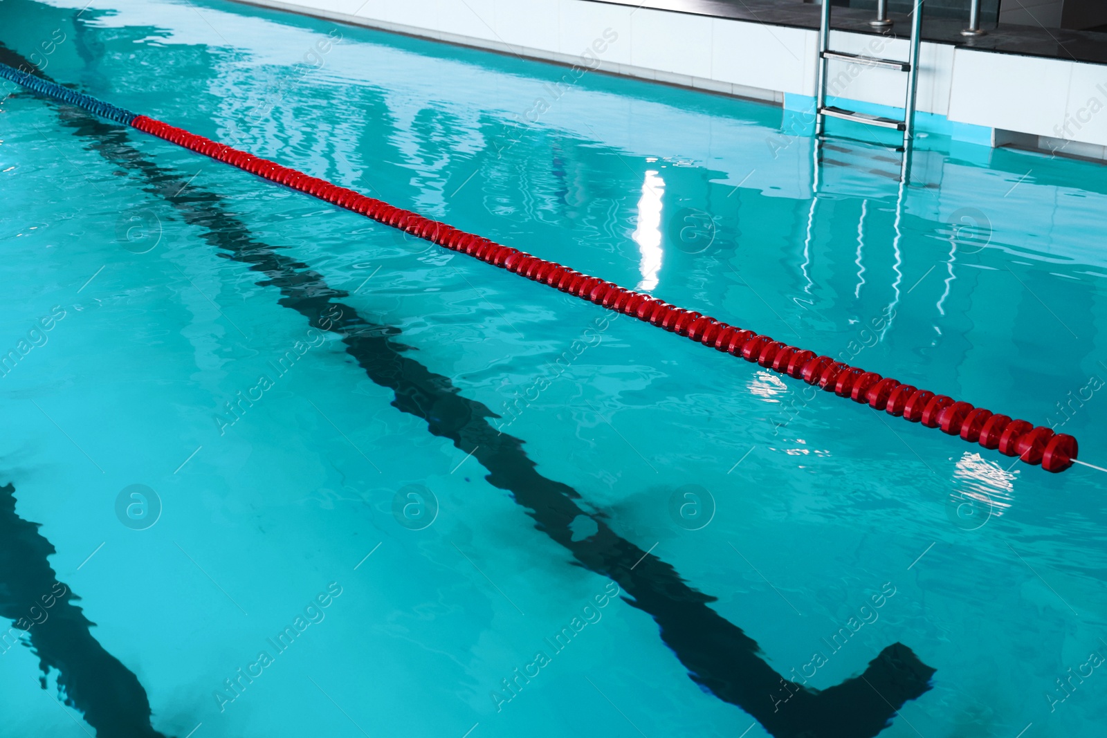 Photo of Swimming pool with clean water and lane dividers indoors