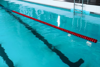 Photo of Swimming pool with clean water and lane dividers indoors