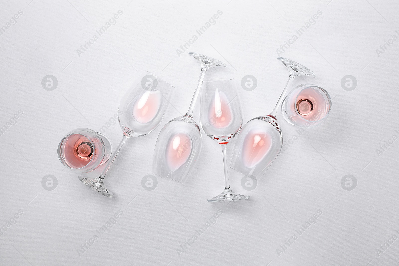 Photo of Many wineglasses on white background, flat lay