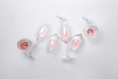 Many wineglasses on white background, flat lay