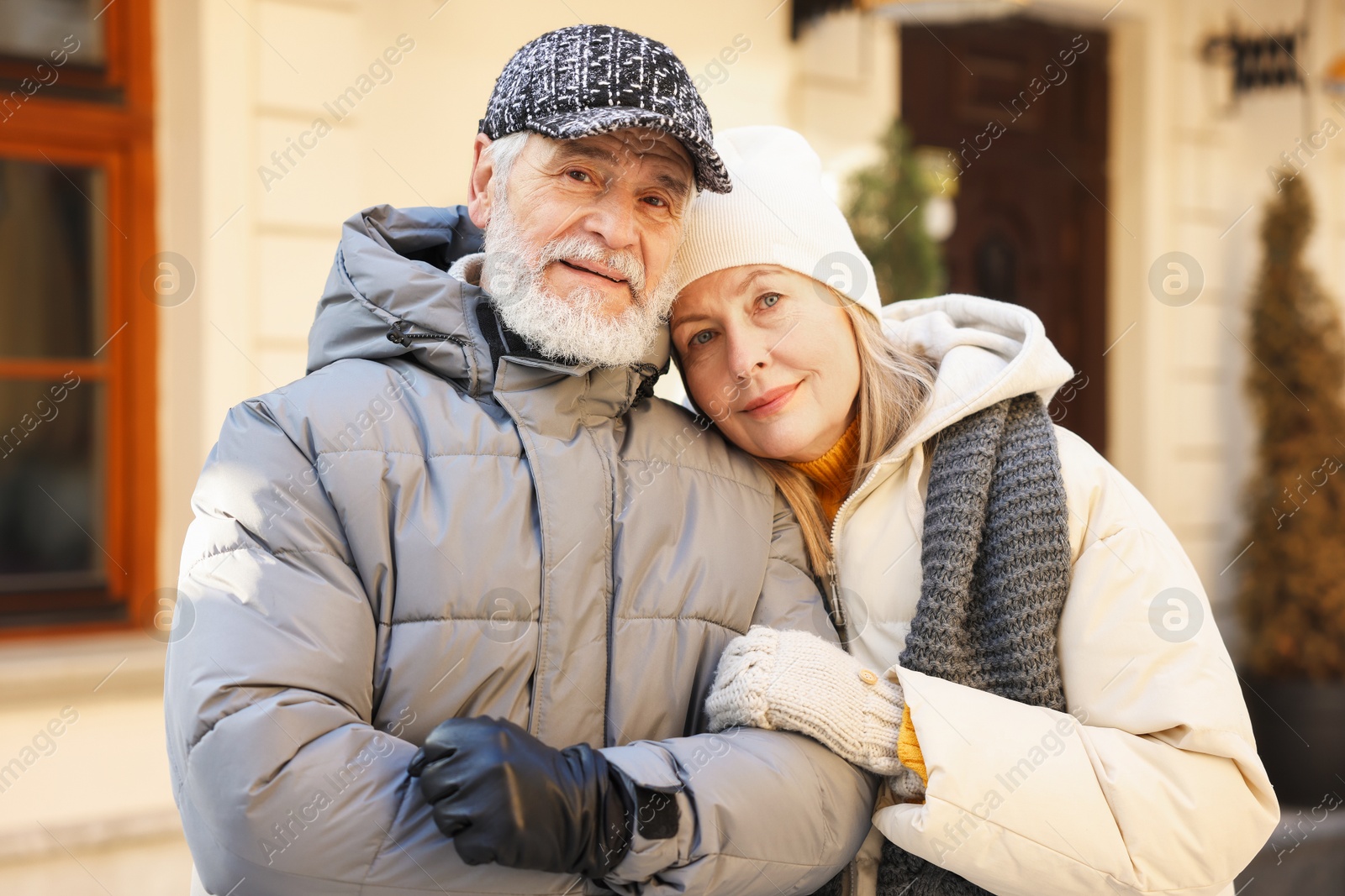 Photo of Family portrait of happy elderly couple on city street