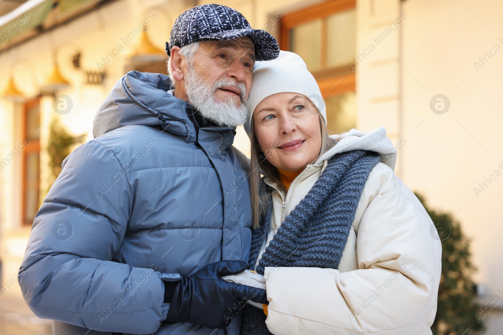 Photo of Lovely elderly couple holding hands on city street