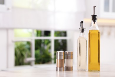 Photo of Salad dressings and spices on table in kitchen. Space for text