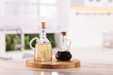 Photo of Salad dressings in bottles on table indoors