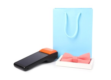 Photo of Payment terminal, shopping bag and bow tie isolated on white