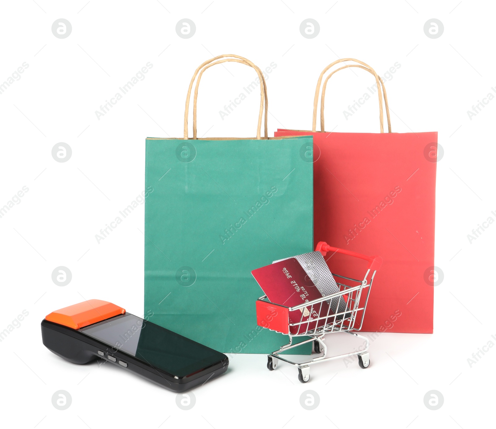 Photo of Payment terminal, shopping bags and mini cart with credit cards isolated on white