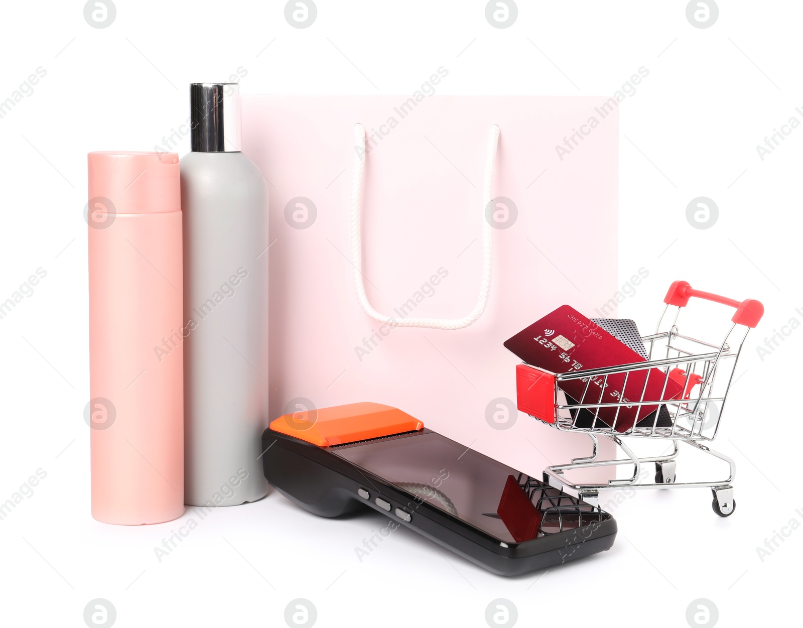 Photo of Payment terminal, cosmetic products, shopping bag and mini cart with credit cards isolated on white