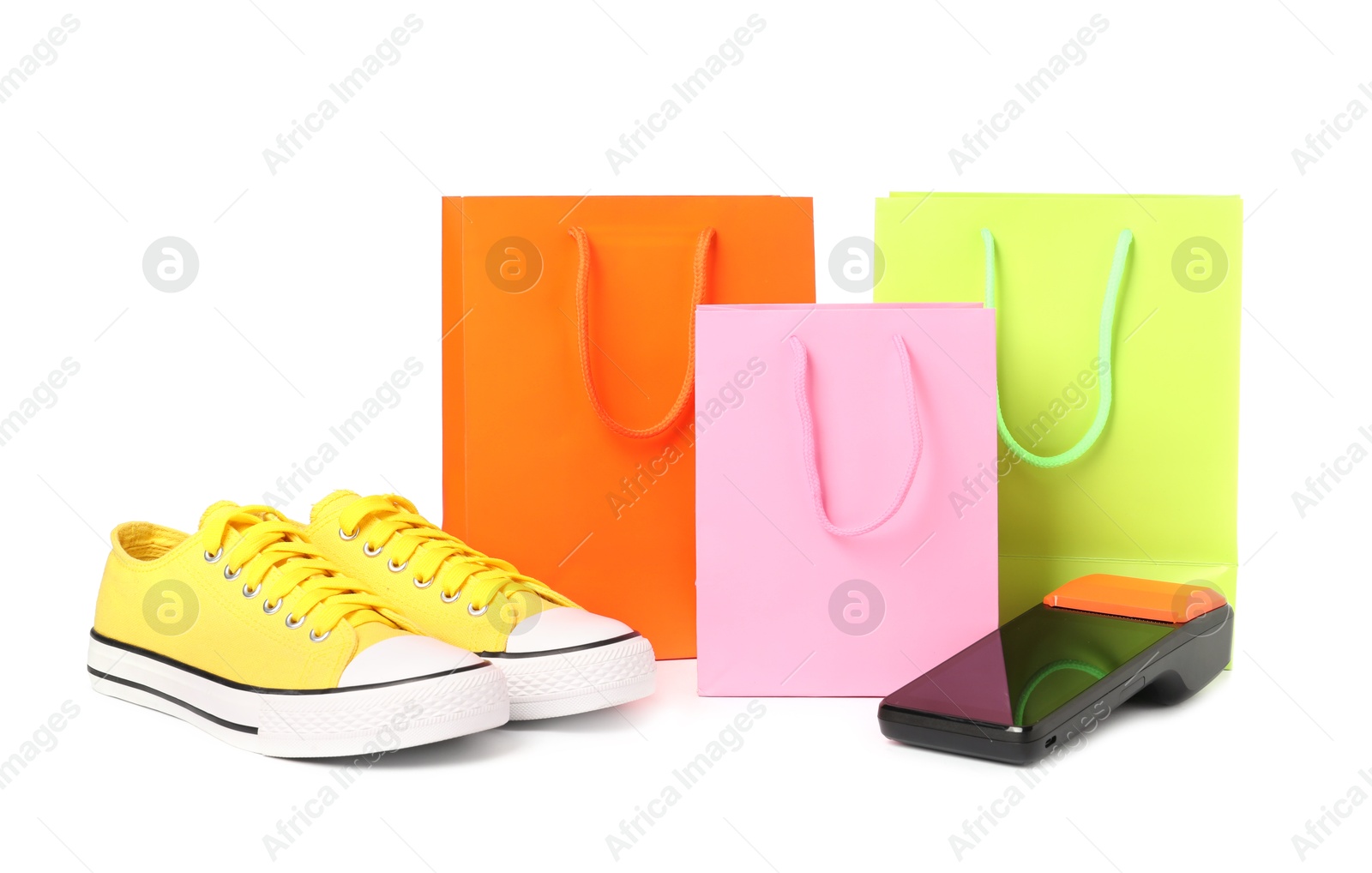 Photo of Payment terminal, shopping bags and sneakers isolated on white