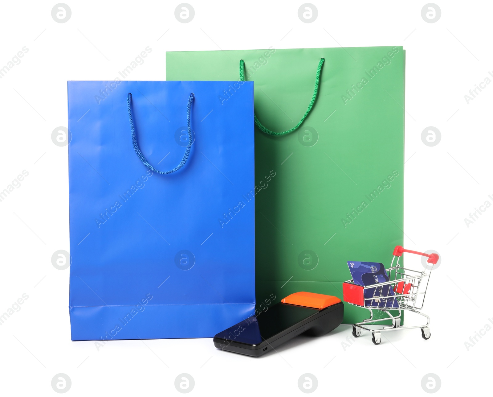 Photo of Payment terminal, shopping bags and mini cart with credit card isolated on white