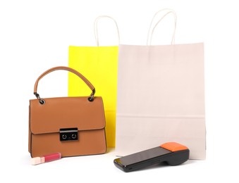 Photo of Payment terminal, shopping bags, handbag and lipstick isolated on white