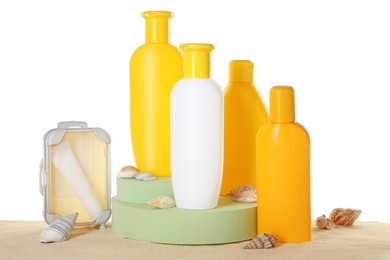 Photo of Different sun protection products and seashells on sand against white background