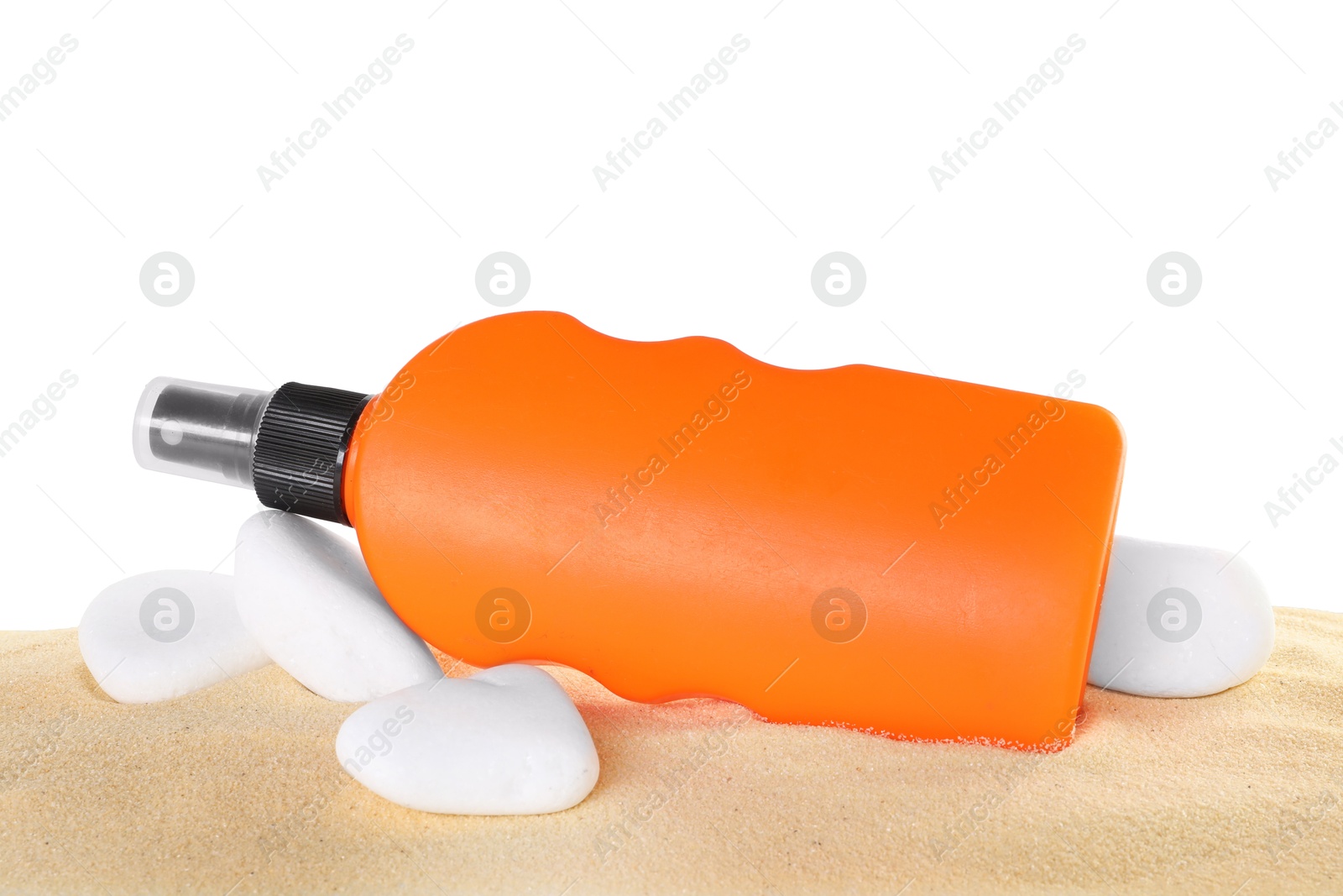 Photo of Bottle of sun protection product and stones on sand against white background