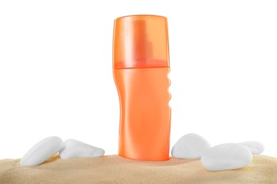 Photo of Bottle of sun protection product and stones on sand against white background