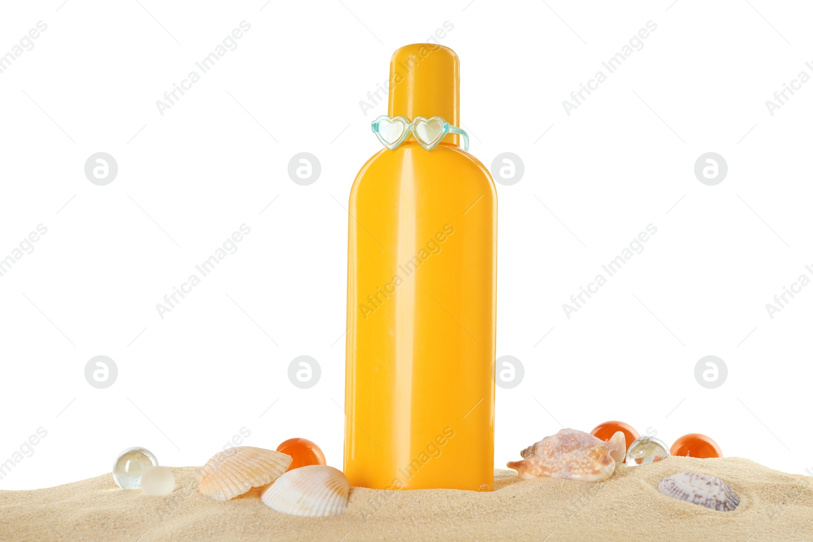 Photo of Bottle of sun protection product, decorative stones and seashells on sand against white background