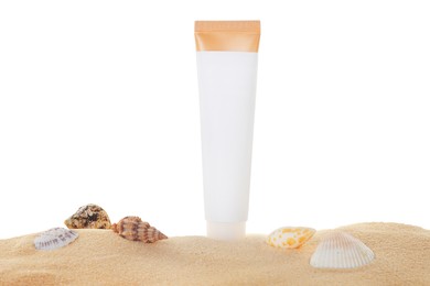 Tube of sun protection product and seashells on sand against white background