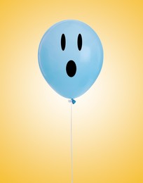 Image of Light blue balloon with shocked face on orange gradient background