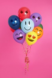 Image of Faces with different emotions on bright balloons against pink background