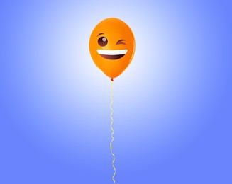 Image of Orange balloon with winking face on blue gradient background