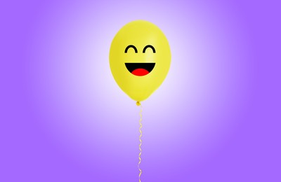 Image of Yellow balloon with happy face on violet gradient background