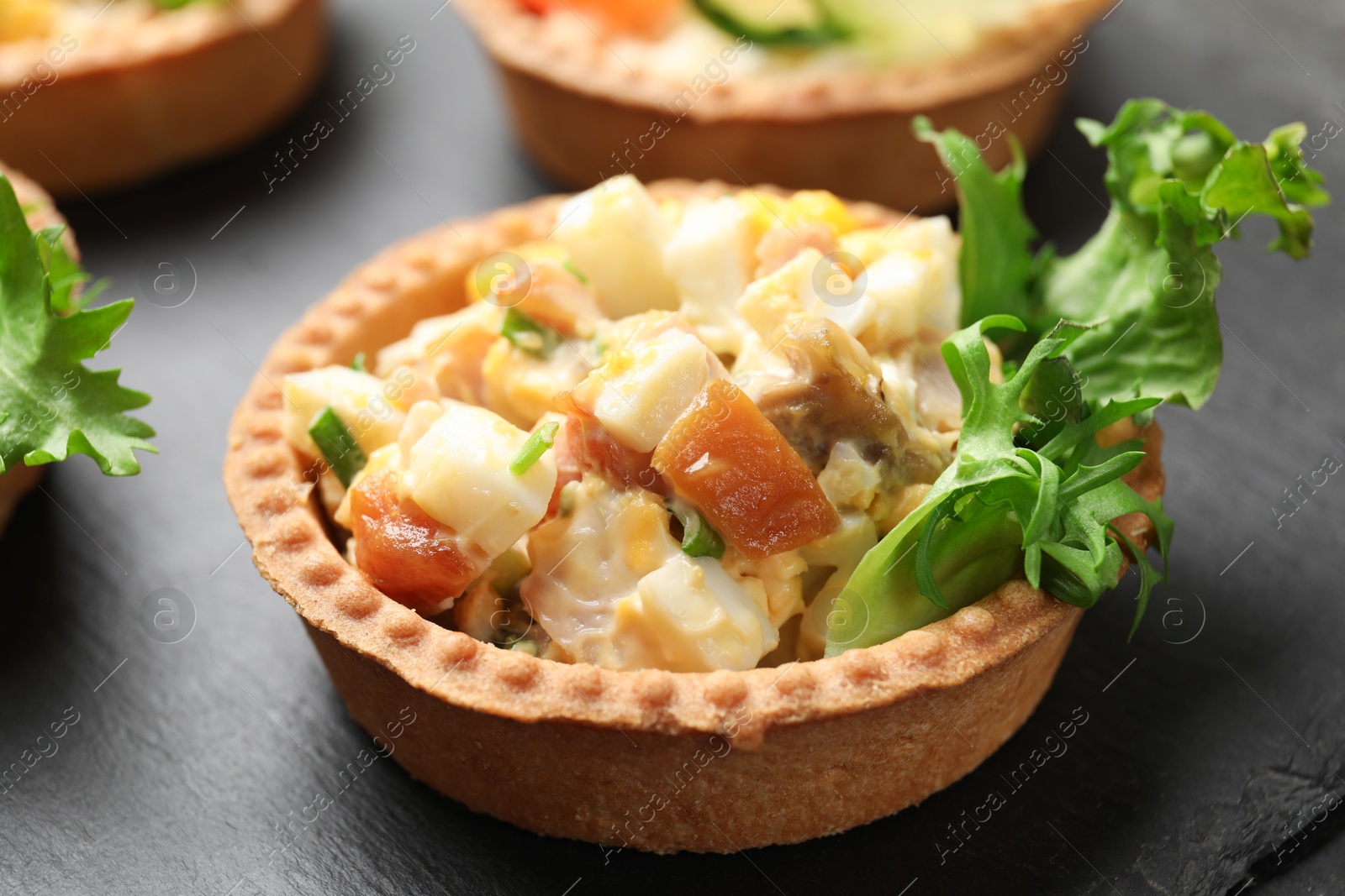Tartlets with delicious filling on black table, closeup Photo of Tartlets with delicious filling on black table, closeup