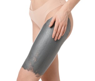 Woman doing spa body wraps on her leg against white background, closeup