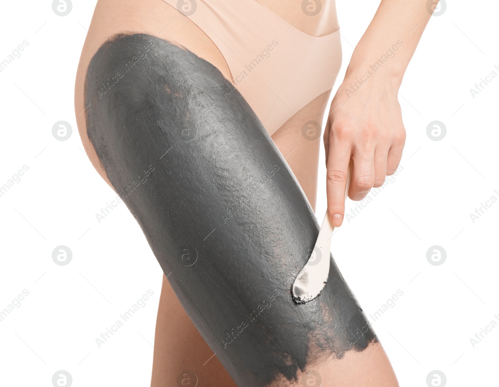 Photo of Woman applying cosmetic product for spa body wraps onto her leg against white background, closeup