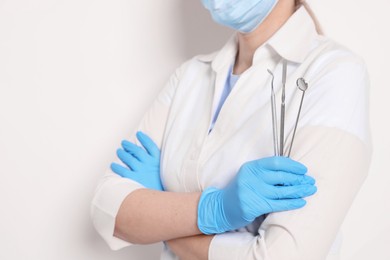 Professional dentist with tools on white background, closeup