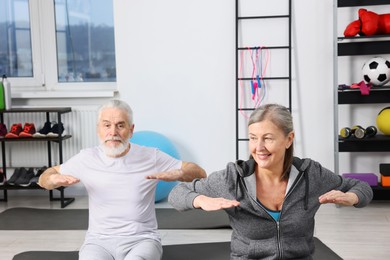 Elderly couple exercising at home. Healthy leisure