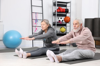 Elderly couple exercising at home. Healthy leisure