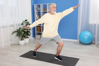 Photo of Elderly man exercising at home. Healthy leisure