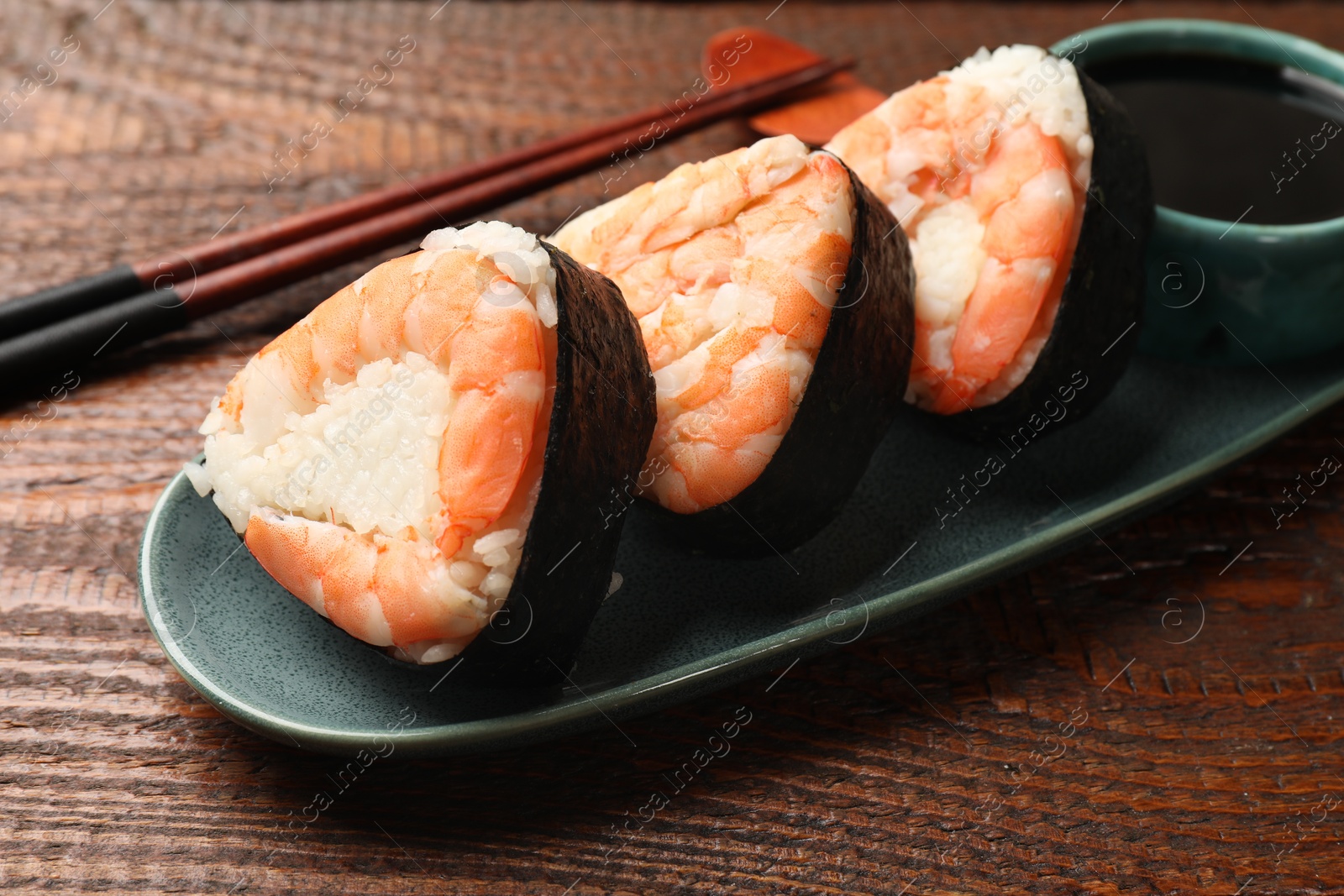 Tasty onigiri (Japanese rice balls) with shrimps served on wooden table, closeup Photo of Tasty onigiri (Japanese rice balls) with shrimps served on wooden table, closeup